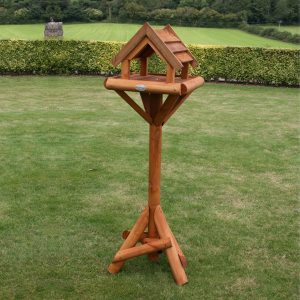 Wooden bird table in garden