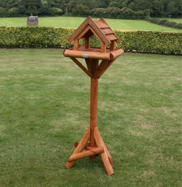 Wooden bird table in garden